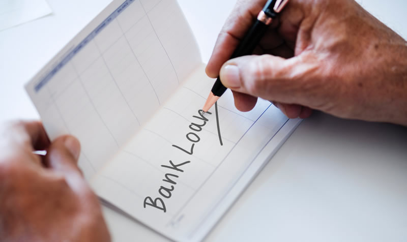 Photo of bank book with 'bank loan' being written