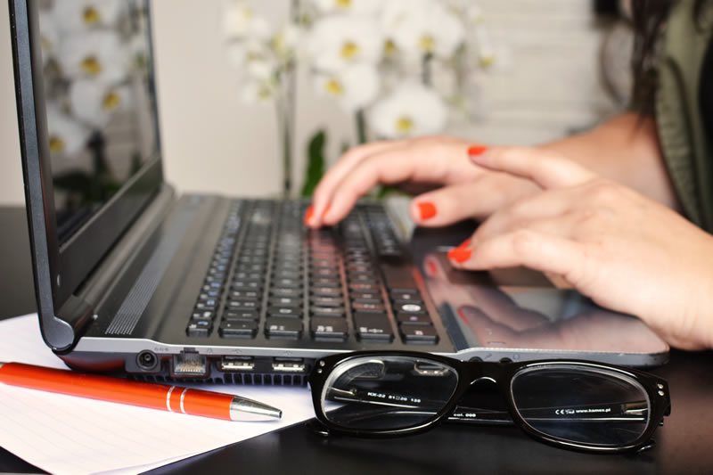 Person typing on a laptop computer