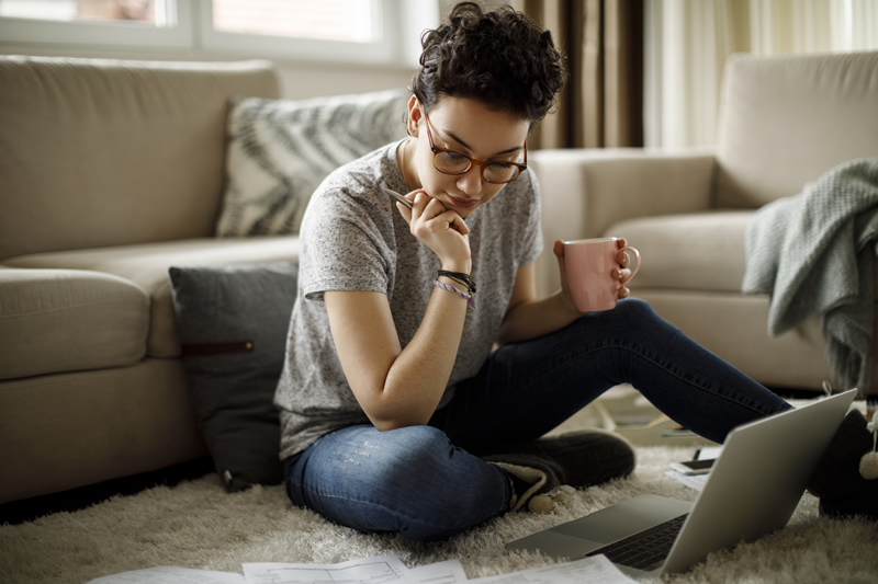 Woman sitting in living room with laptop