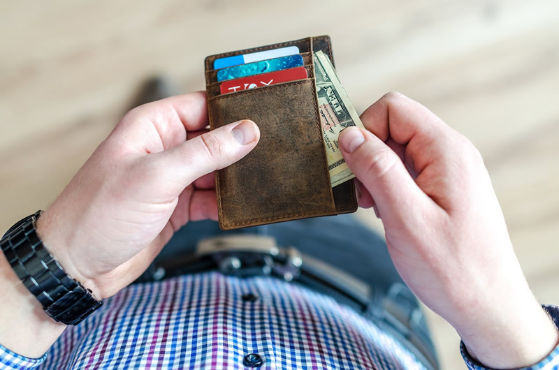 Photo of man holding wallet