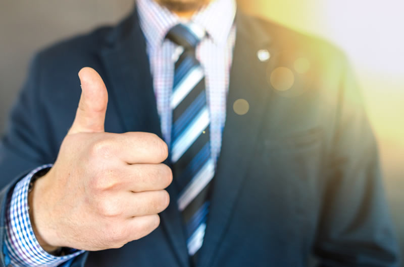 Business man with thumbs up sign