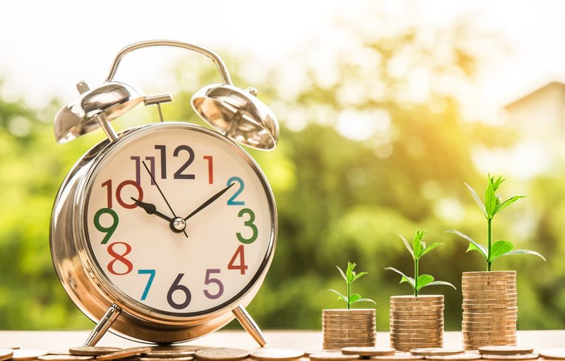 Clock and stacks of coins
