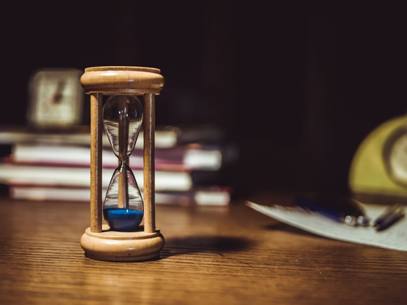 An hourglass on a desk